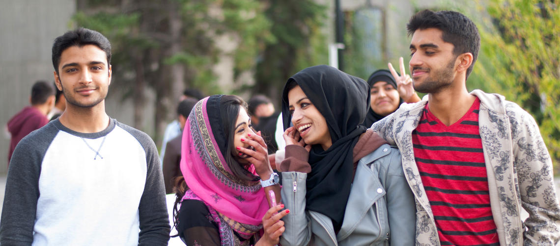 four students walking on campus