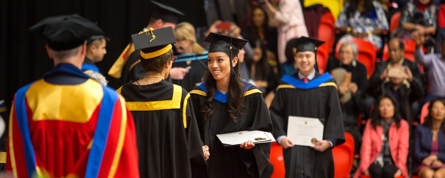 graduands lining up to cross the stage