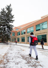 students walking on main campus near the Professional Faculties building