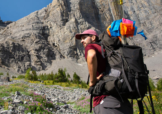 A researcher hiking in the Rocky Mountains