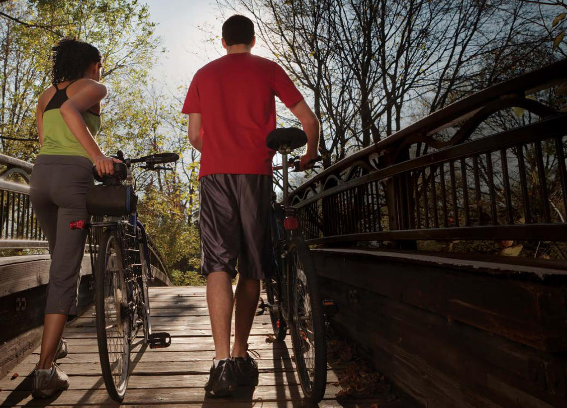 couple walking bikes