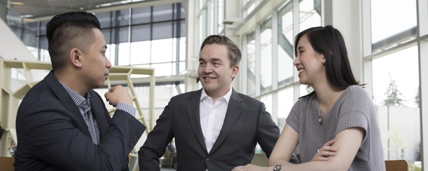 Adult learners chat together in UCalgary's Taylor Family Digital Library