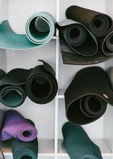 multiple yoga mats on a wall