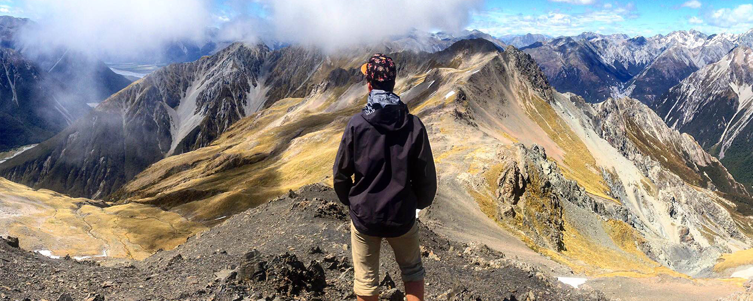 Man Stands takingin the mountain view